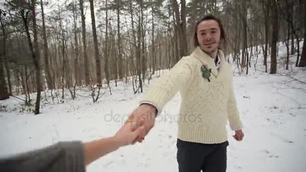 Novia y siguiendo a su novio en el bosque de invierno — Vídeos de Stock