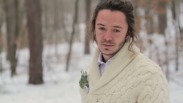 Портрет молодого посміхаючись людини в зимовому лісі — стокове відео