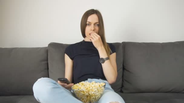 Avslappnad tjej klockor Tv med Popcorn — Stockvideo