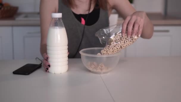 Mujer lanza cereal en un tazón — Vídeo de stock