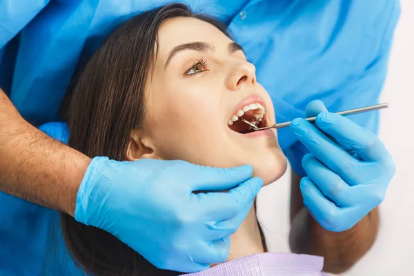 Dentist Examines Patients Teeth