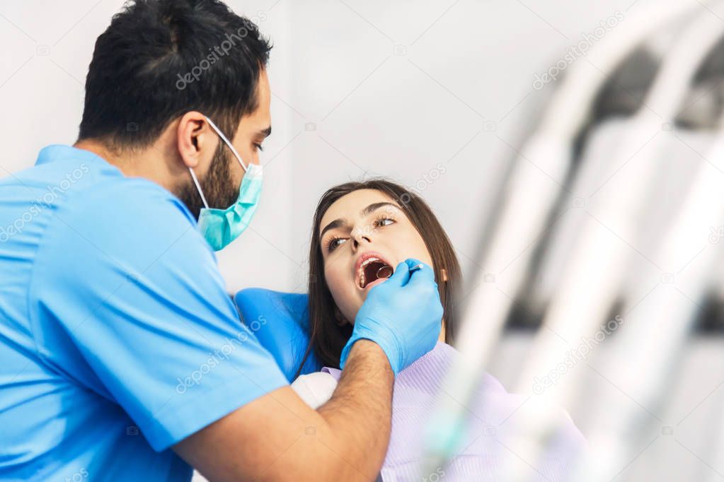 Dentist Talks to Patient During Check Up