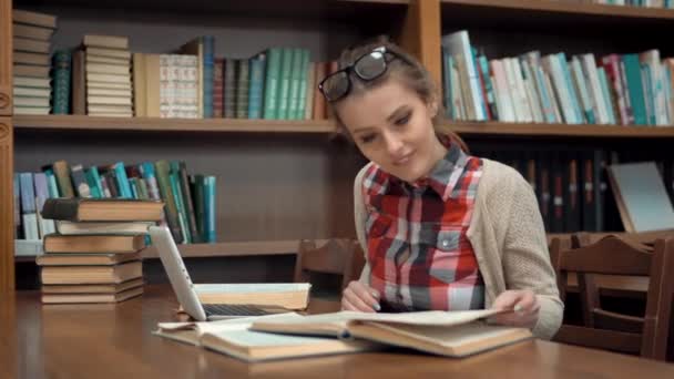 Menina na mesa da biblioteca — Vídeo de Stock