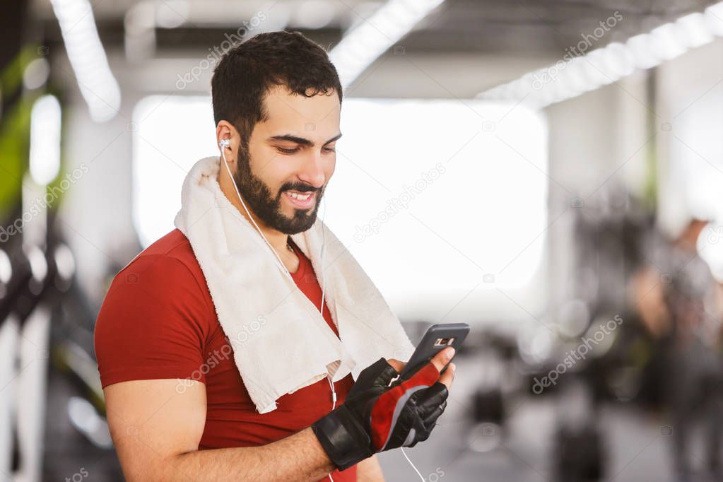 Man with Smartphone in the Gym