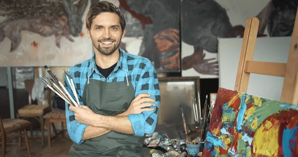 Young Smiling Artist Posing in Loft Studio Stok Gambar