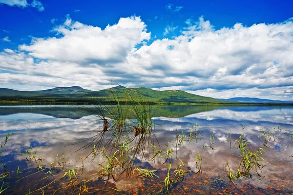 Azurblå Sjö Med Återspegling Himmelens Skyar Vid Foten Bergen — Stockfoto