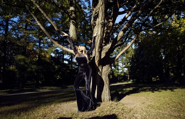 Beautiful Blonde Girl Posing Black Velvet Costume Stock Image