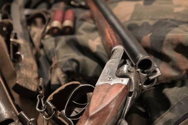 antique double-barreled shotgun, knife and ammunition belt clipart