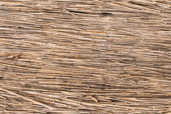 Mat van oude bruine rieten, horizontaal muur — Stockfoto