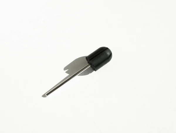 One sanding cap rubber mandrel. White backgound. Drill bits