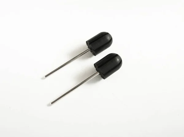 Two sanding cap rubber mandrels. White backgound. Drill bits, Same sizes