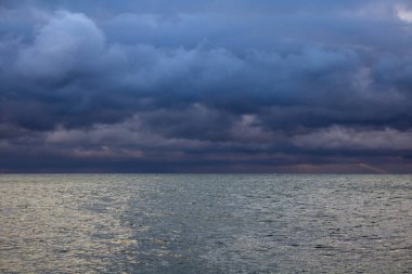 blue dark cumulus stormy clouds above the sea