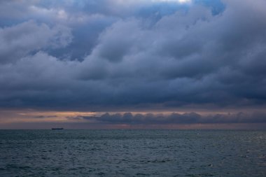 blue dark cumulus stormy clouds above the sea