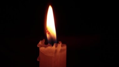 close-up of the candlelight in the darkness