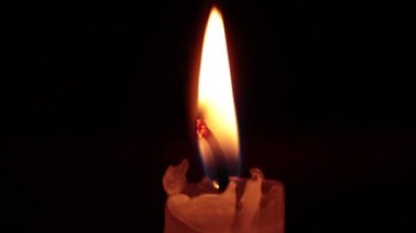 close-up of the candlelight in the darkness