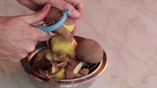 Man Peeling Potatoes Kitchen Metal Pan — Stock Video