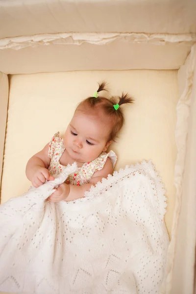5 months old lovely baby girl in the crib — Stock Photo, Image