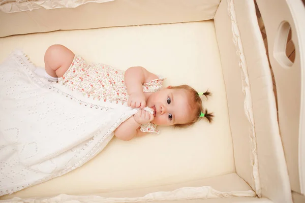 5 months old lovely baby girl in the crib — Stock Photo, Image