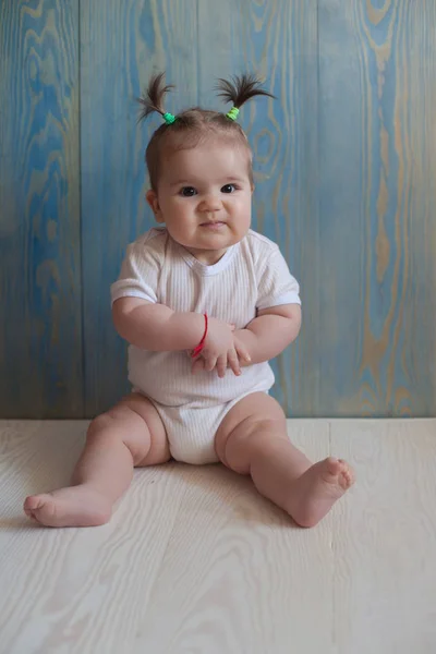 Adorable Baby Girl with  Sitting on a wooden floor — Stock Photo, Image