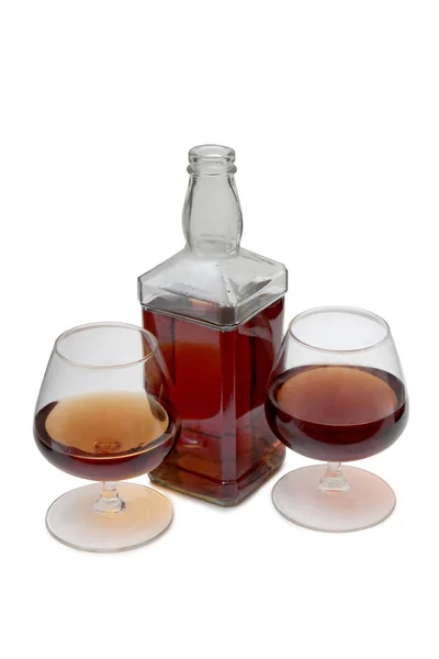 Cognac flaska på vita sex — Stockfoto