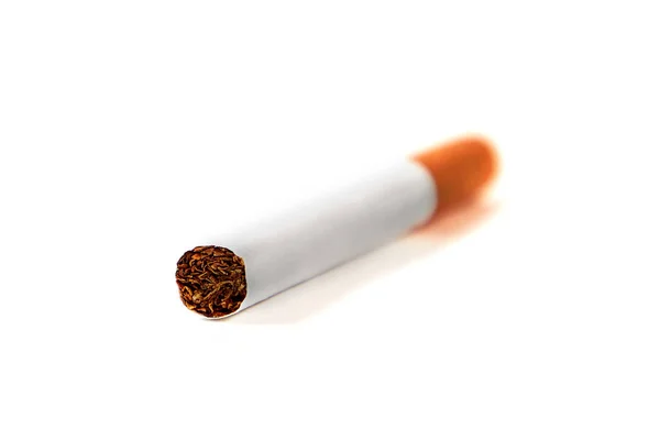One cigarette lies with a filter to us on a white background — Stock Photo, Image
