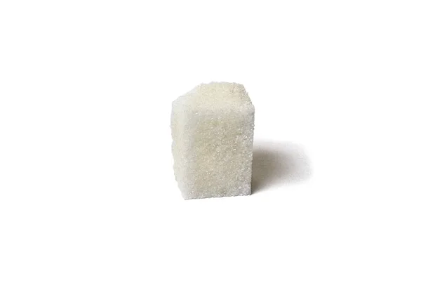 Bulto de azúcar único con migas de azúcar aisladas de blanco — Foto de Stock