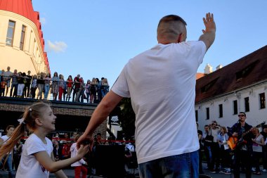 June 1, 2019 Minsk Belarus A father holds the hand of his happy daughter at a street concert