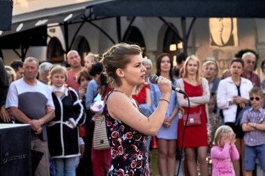 25 Mayıs 2019 Minsk Belarus. Sokakta mikrofonlu genç ve güzel bir kadının durduğu bir tiyatro gösterisi.