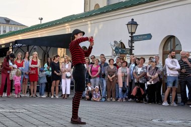 May 25, 2019 Minsk Belarus Close-up, girl actress shows theatrical performance with a red ball at the street.