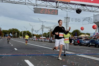 15 Eylül 2019 Minsk Belarus. Kulaklıklı bir sporcunun bitiş çizgisini geçtiği bir maraton yarışı.