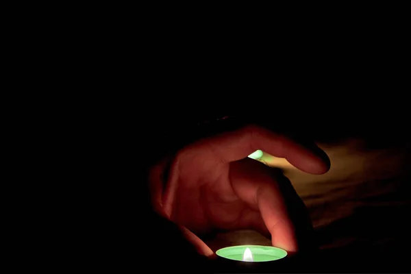 Human Hand Places Burning Green Candle Table Next Burning Candle — Stock Photo, Image