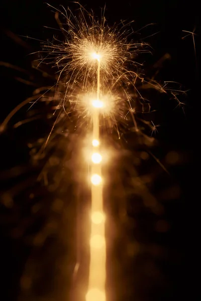 Line of sparkling lights in darkness — Stock Photo, Image