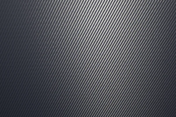 Close up of grey diagonal oriented woven carbon fibre sheet surface. — Stock Photo, Image