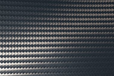 Gri karbon fiber doku yüzeyinin makro fotoğrafı.