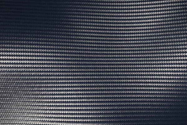 Grigio tessuto superficie in fibra di carbonio con riflessione della luce . — Foto Stock