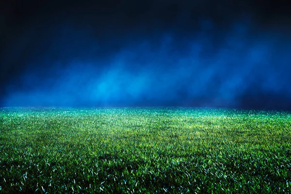 Close up of maintained lawn at football stadium. Night low view with abstract light effects. Iluminated mist.