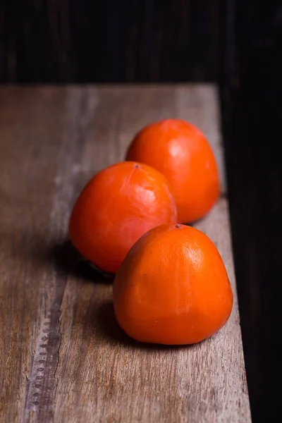 Three raw persimmon — Stock Photo, Image