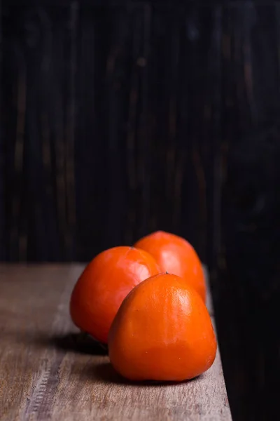 Three raw persimmon — Stock Photo, Image