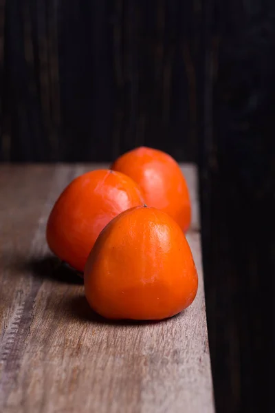 Three raw persimmon — Stock Photo, Image