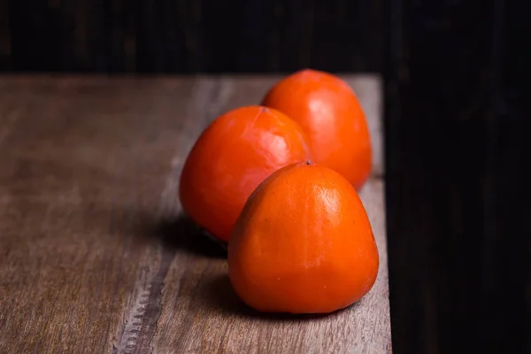 Three raw persimmon — Stock Photo, Image