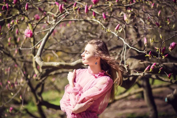 Dívka pózuje v zahradě magnolia — Stock fotografie