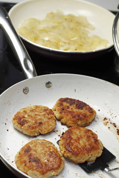 Cooking Four Turkey Patties and Onions — Stock Photo, Image