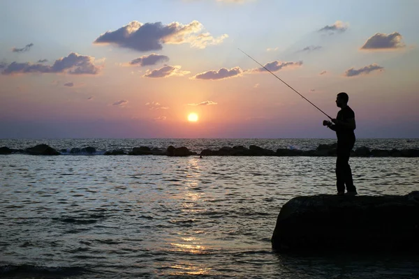 Fiskare och solnedgång — Stockfoto