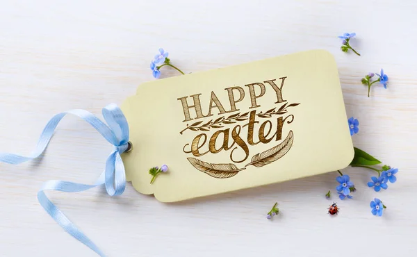 Easter card and spring flovers on wood background — Stock Photo, Image