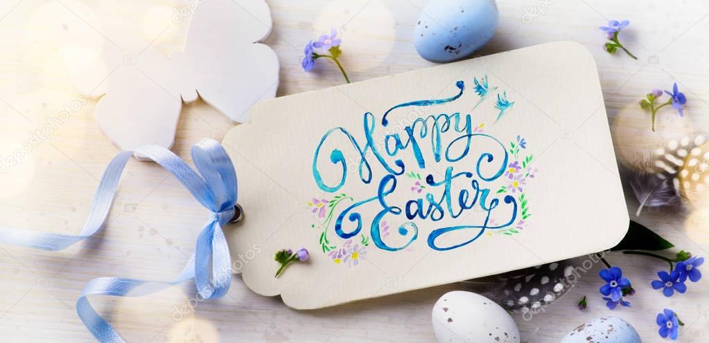 Easter card; Easter eggs and spring flovers on wood background 