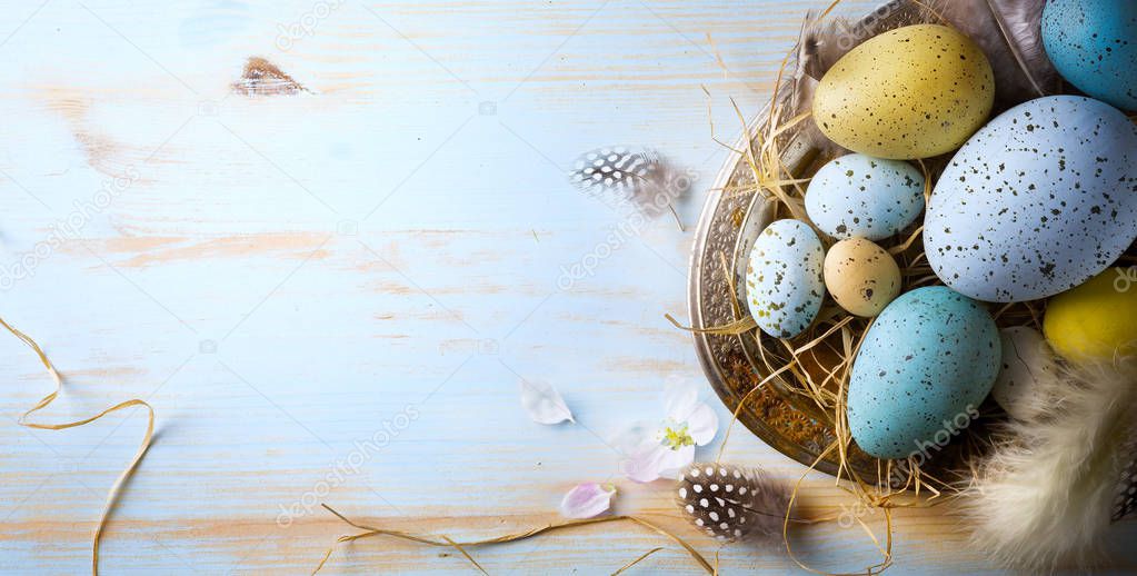 Easter background with Easter eggs and spring flowers. Top view 