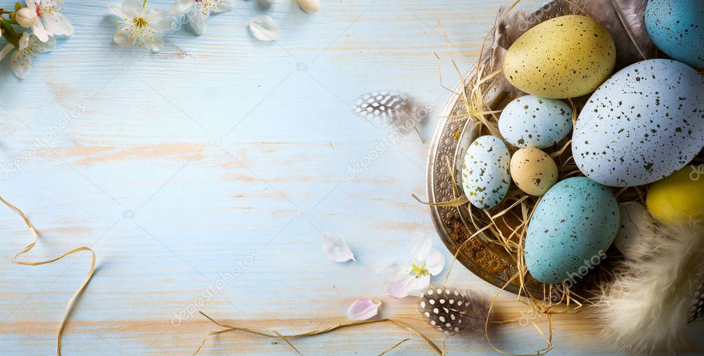 Easter background with Easter eggs and spring flowers. Top view 