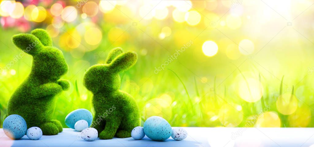 Happy Easter Day; Easter rabbit Bunny And Decorated Eggs In Flowery Field; Holiday banner background