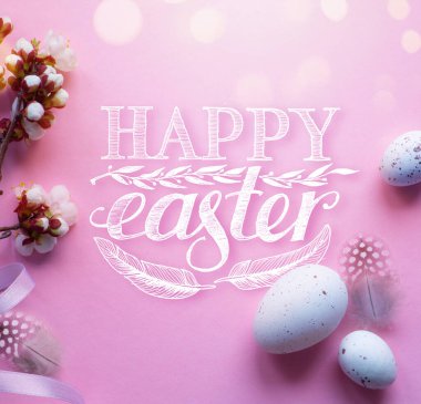 Easter eggs and Beautiful spring cherry tree flowers on pink background. Springtime Easter background;