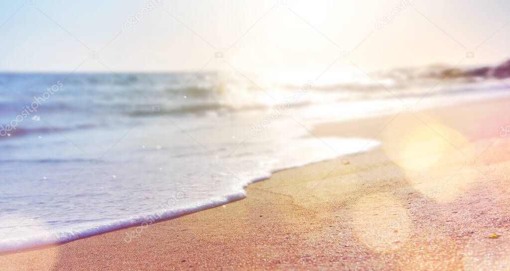 abstract summer background of blurred beach and sea wave